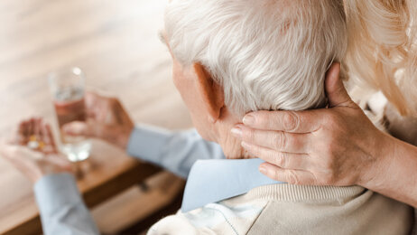 Bildet viser eldre mann som får medisiner