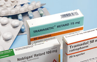 Bildet viser noen brett med tabletter samt tablettesker med ulike smertestillende tabletter