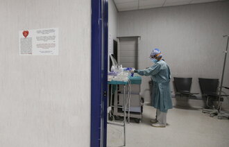 Bildet viser en sykepleier kledd i beskyttelsesutstyr.