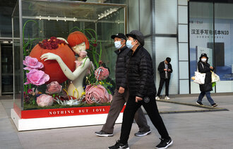 Bildet viser to tilfeldig forbipasserende på gaten i Beijing.