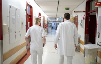 Ansatte går i sykehuskorridor