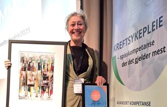 Bildet viser Hege Birketvedt Eklund med kunst og diplom.