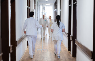 Bildet viser helsepersonell i en korridor