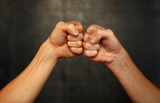 bildet viser en manns- og en kvinnehånd knyttet mot hverandre