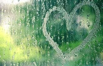 Bildet viser en vidusrute full av regndråper med et hjerte tegnet inn i dugget.