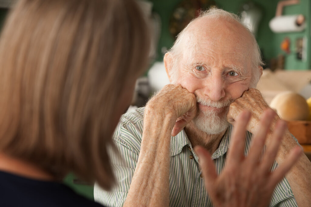 Bildet viser en eldre mann som studerer en kvinne som prater til ham.