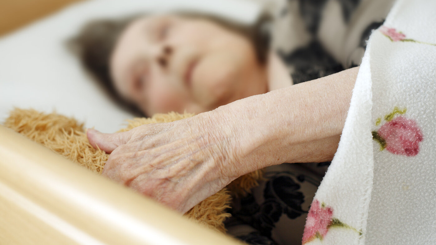 Bildet viser eldre kvinnelig pasient i sykehusseng