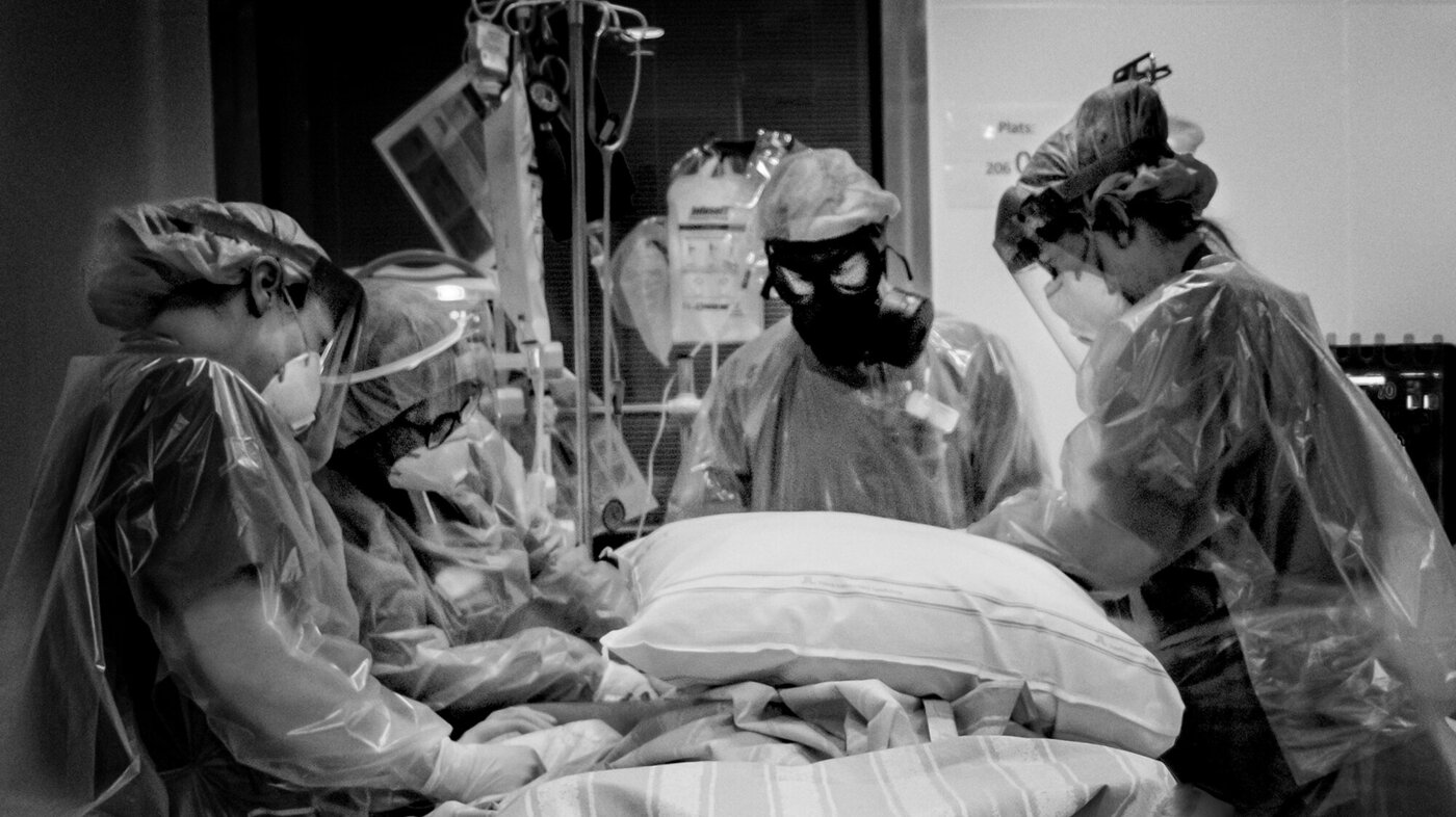 Bildet viser helsepersonell som jobber med en intensivpasient.