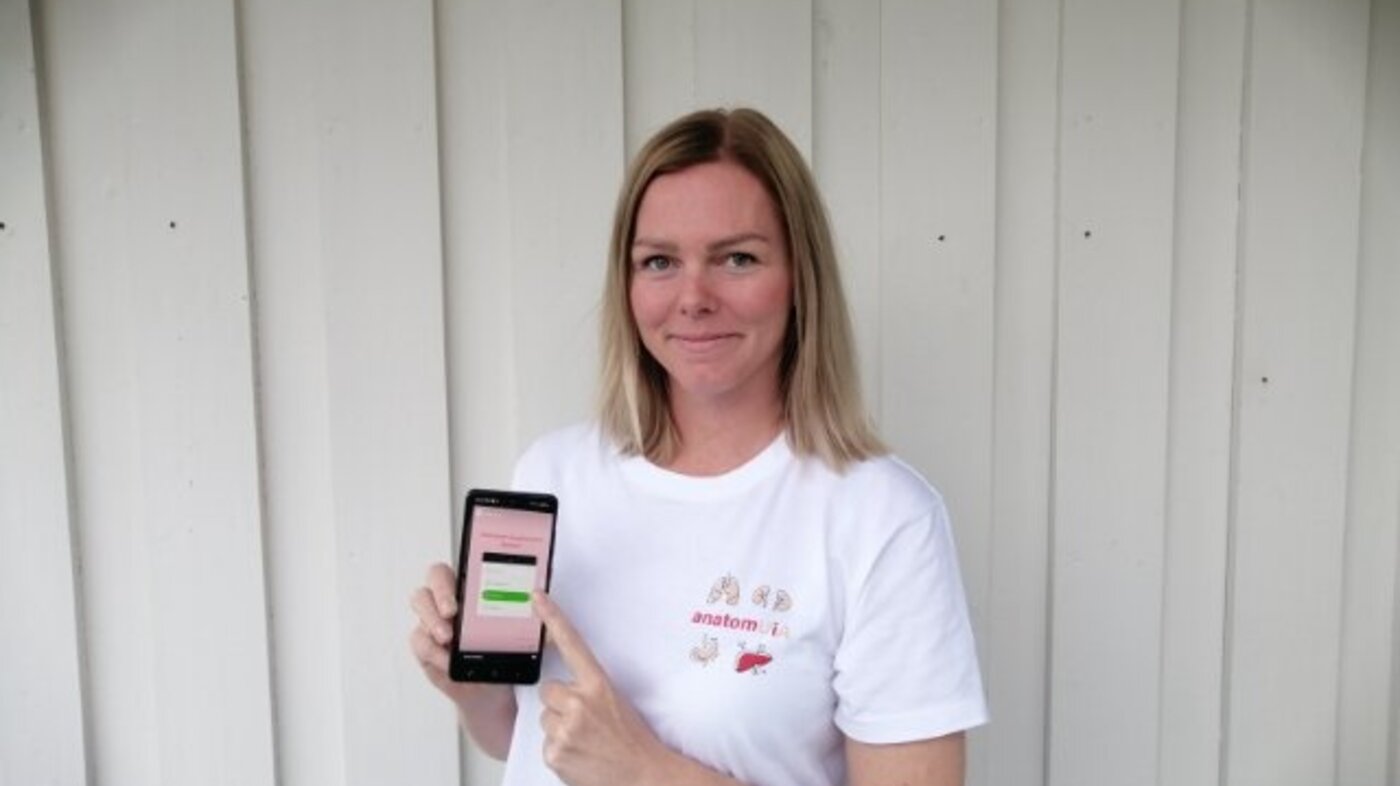 Bildet viser Ann Kristin Nygård med en mobiltelefon.