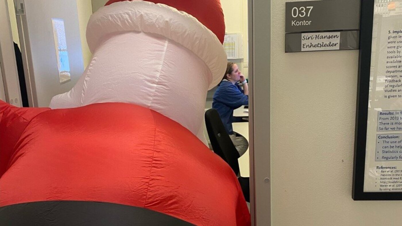 Bildet viser julenissen som titter inn på et kontor på Ahus.