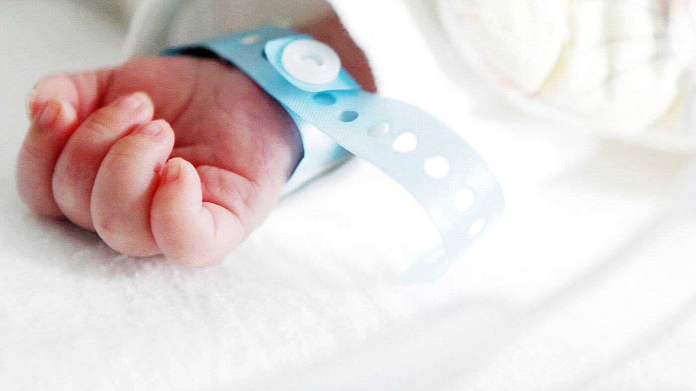 Bildet viser hånden til en nyfødt baby.