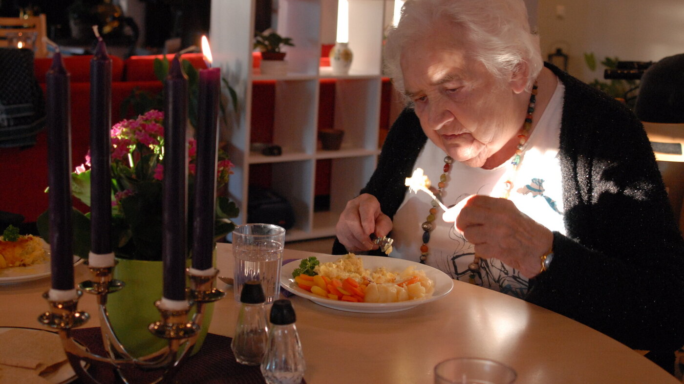 Bildet viser beboer Marit Torp som inntar middagsmaten ved Løten helsetun.