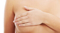 Bildet viser en naken kvinne som holder hånden over det ene brystet.