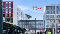 Bildet viser St. Olavs hospital i Trondheim vinters tid. Over bygningene svever et ambulansehelikopter